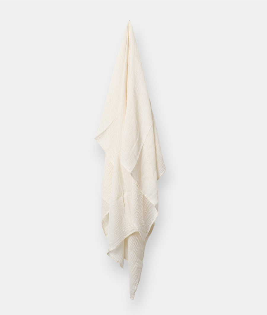 Cream-colored organic cotton towel hanging on a white background - Industry of All Nations