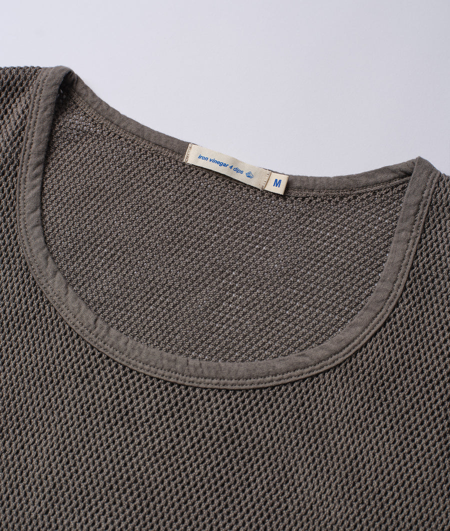 A close-up detail shot of a charcoal grey organic cotton crewneck sweater with a woven label - Industry of All Nations