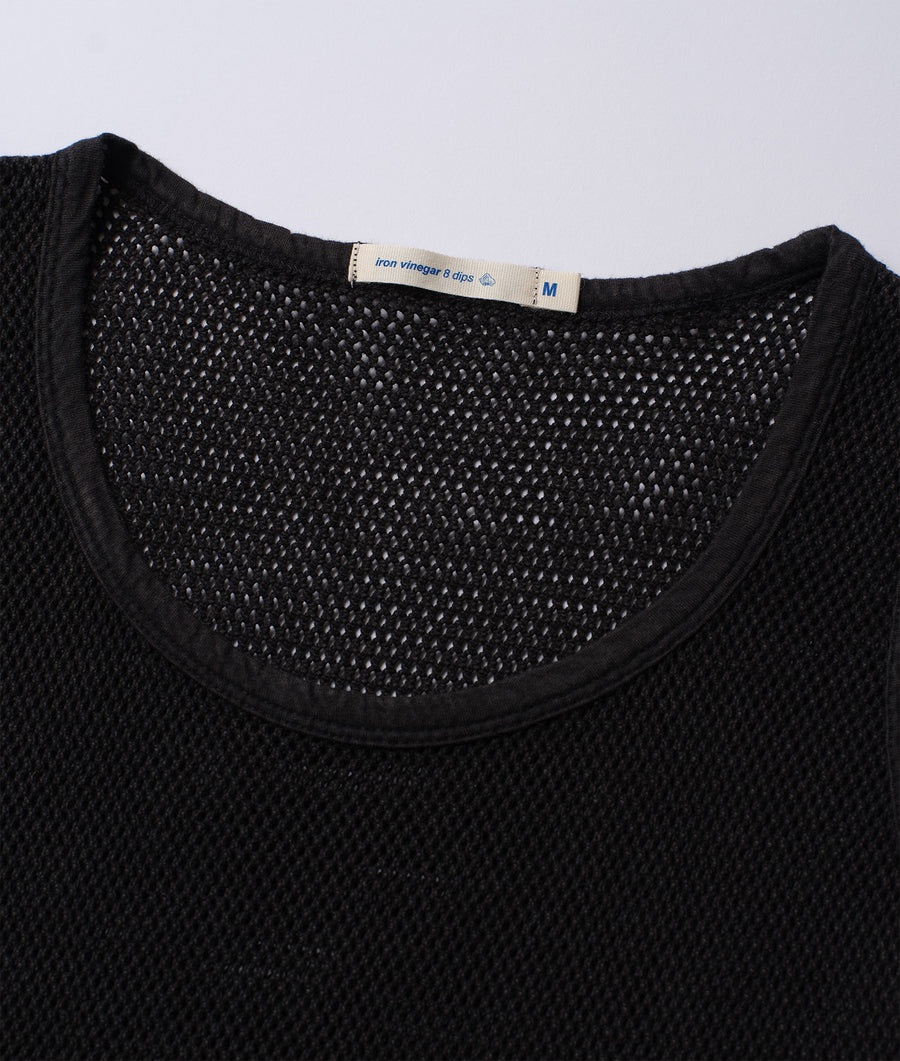 Detail shot of a black mesh knitted shirt, showing the textured pattern - Industry of All Nations