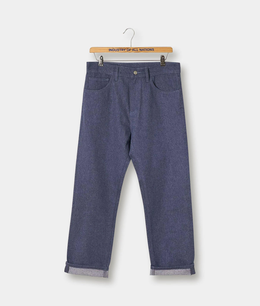 A pair of dark grey denim pants hanging on a wooden hanger with "Industry of All Nations" text - Industry of All Nations