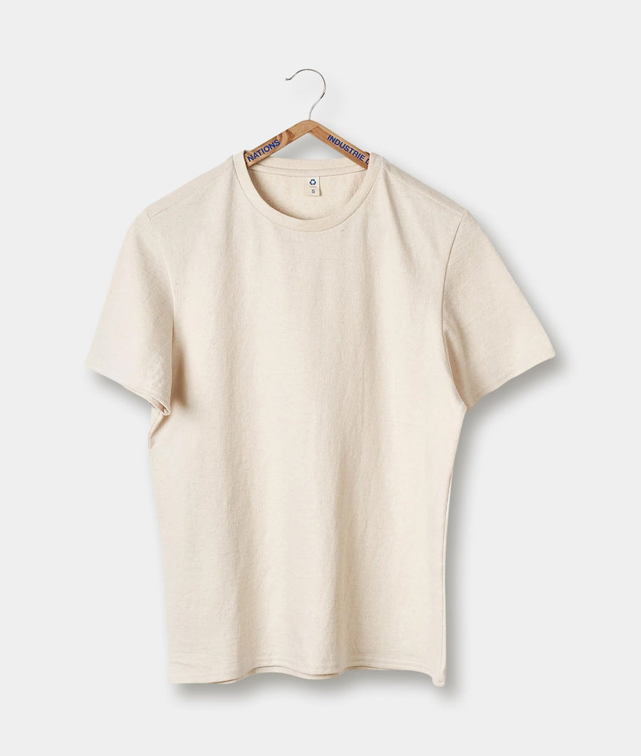 Beige organic cotton t-shirt hanging on a wooden hanger with "Nations" and "Industrie" text - Industry of All Nations
