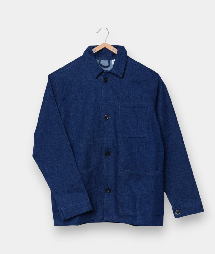 Blue denim chore jacket displayed on a wooden hanger - Industry of All Nations
