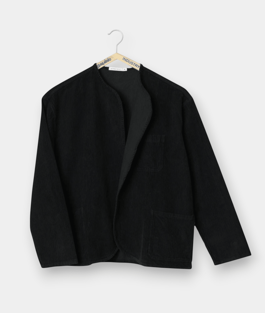 Black wool jacket hung on a hanger against a white background - Industry of All Nations