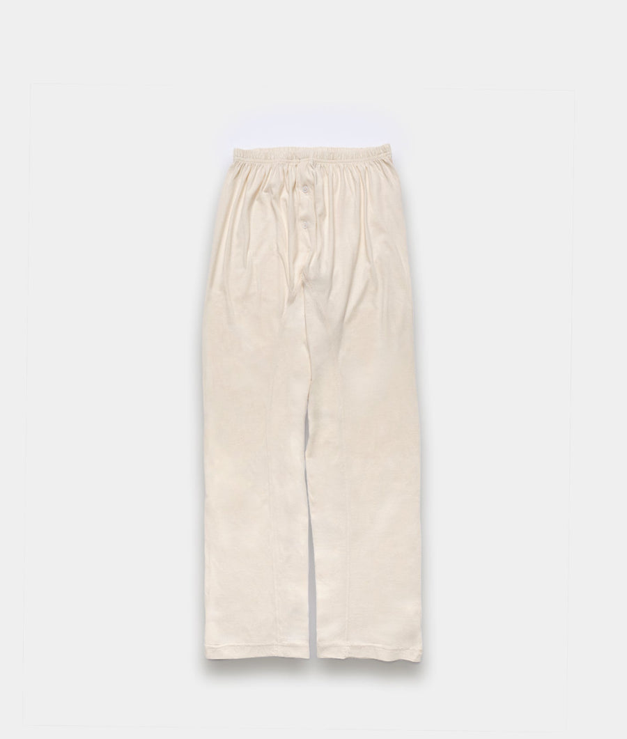 Cream-colored loose cotton bottoms displayed flat against a plain background - Industry of All Nations