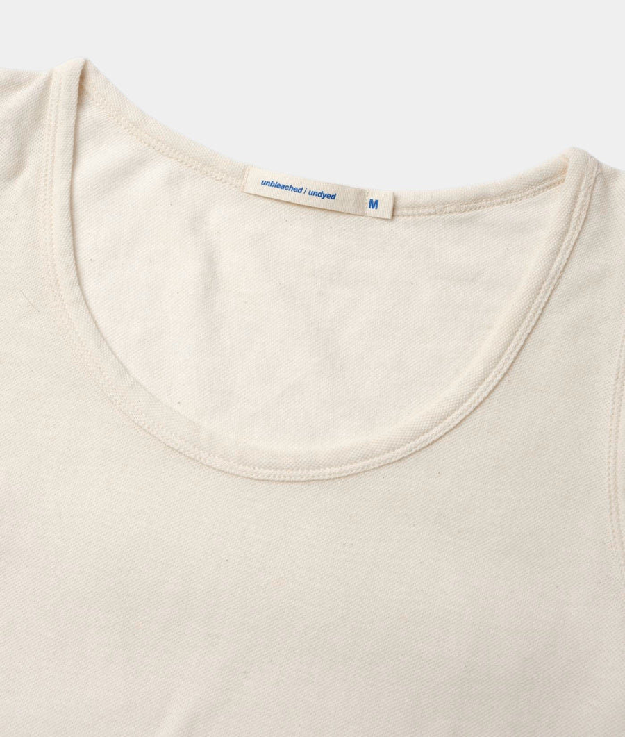 Close-up of the IOAN Pique Tank Dress in Undyed organic cotton, showing the neckline and textured pique fabric.