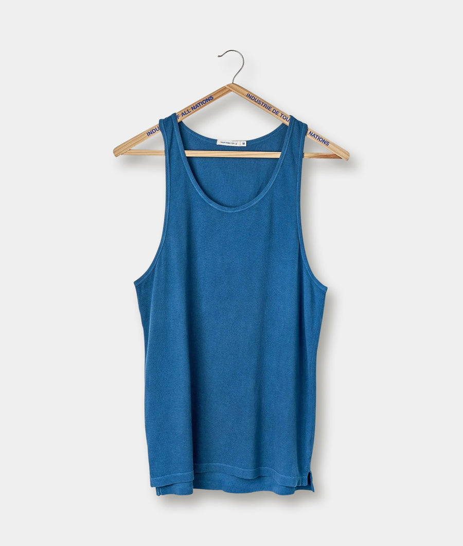 Blue sleeveless tank top hanging on a wooden hanger with "Industry of All Nations" text on the hanger - Industry of All Nations