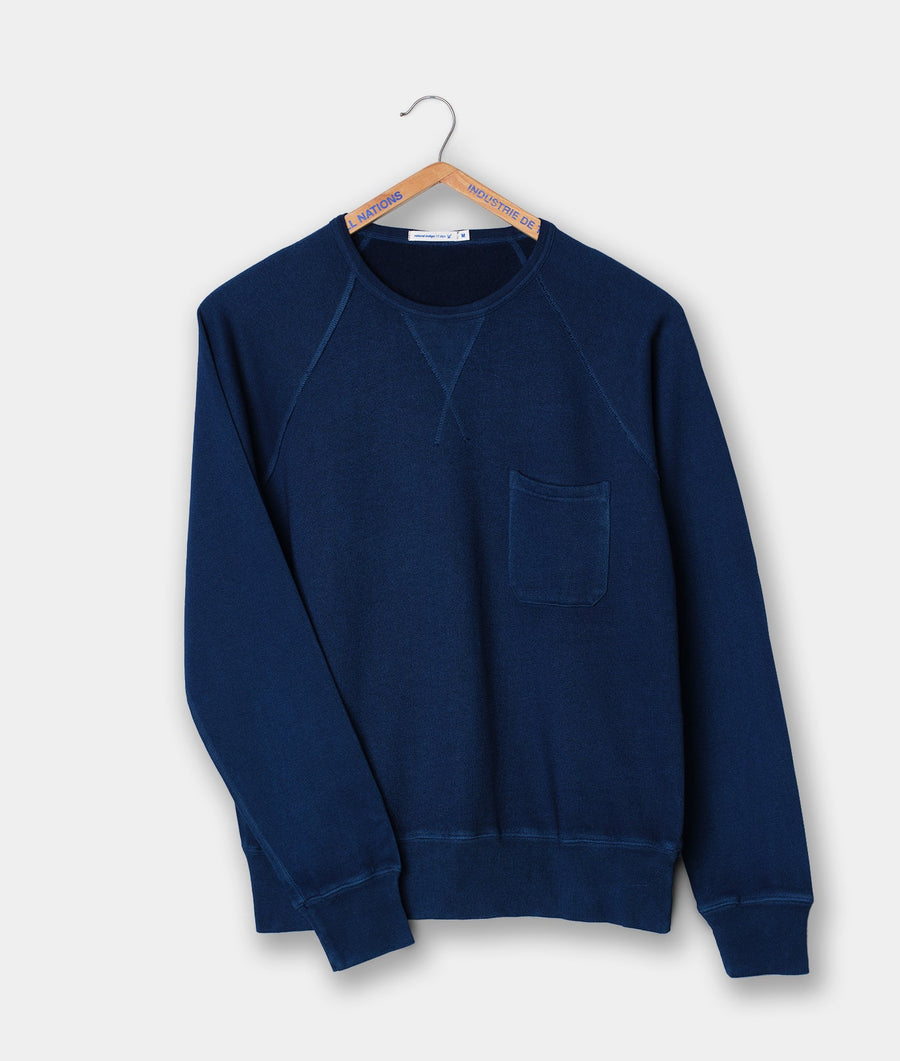 Navy blue crew neck sweatshirt with a single front pocket, displayed on a wooden hanger - Industry of All Nations