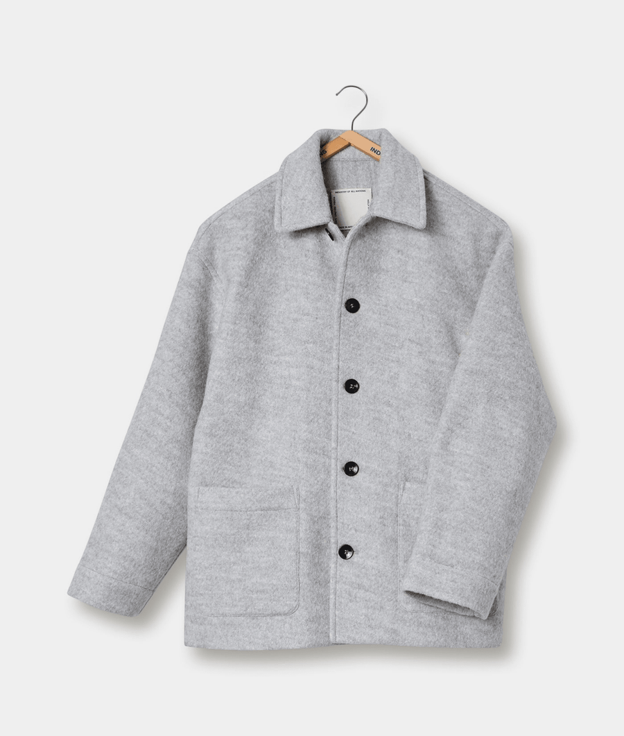 Gray wool jacket hanging on a wooden hanger - Industry of All Nations