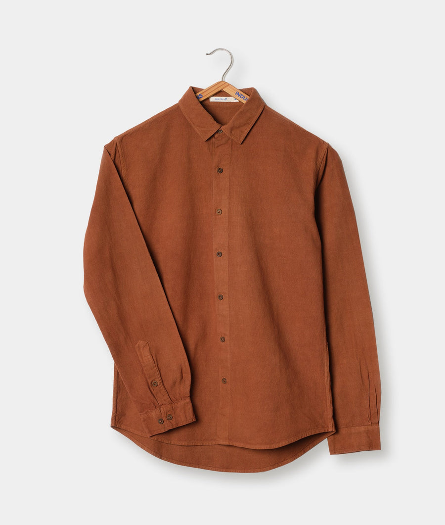 Long-sleeved button-down shirt in rust brown, displayed on a hanger - Industry of All Nations