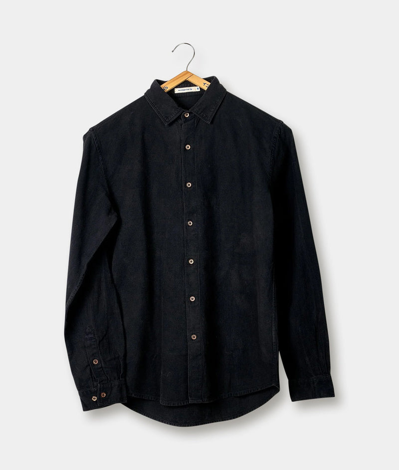 Black denim long-sleeve shirt hanging on a wooden hanger against a plain background - Industry of All Nations