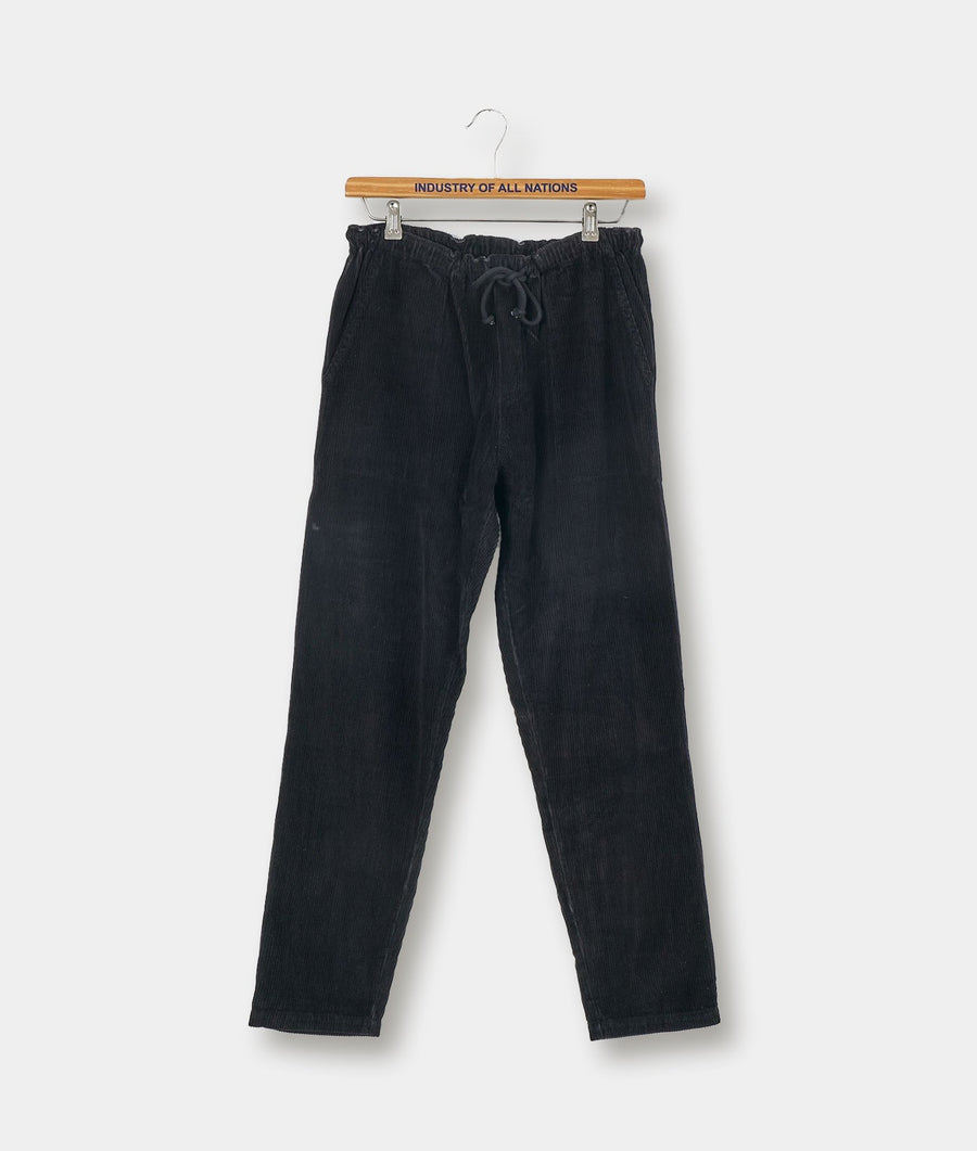 Black cotton drawstring pants displayed on a hanger against a white background - Industry of All Nations