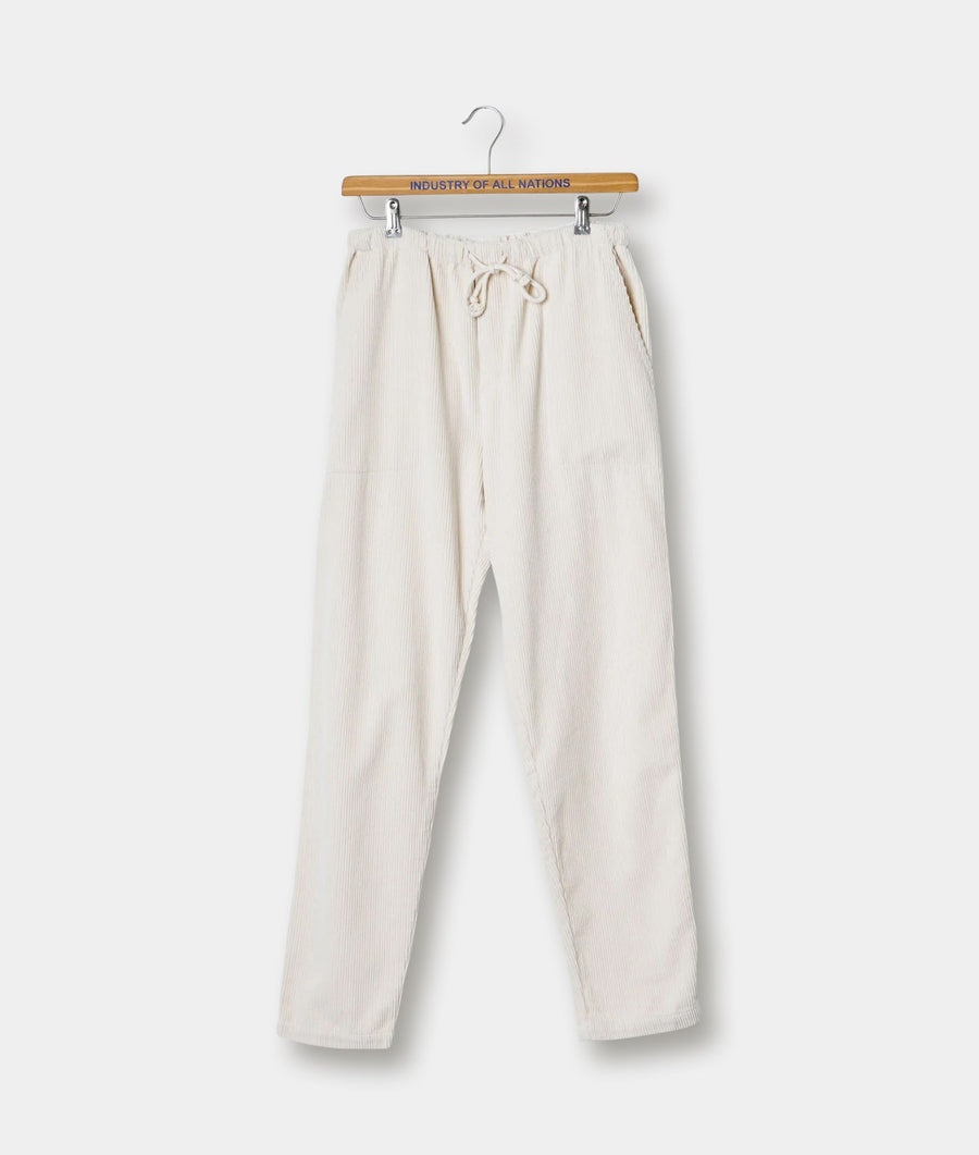 Beige corduroy drawstring pants displayed on a wooden hanger with "Industry of All Nations" branding - Industry of All Nations
