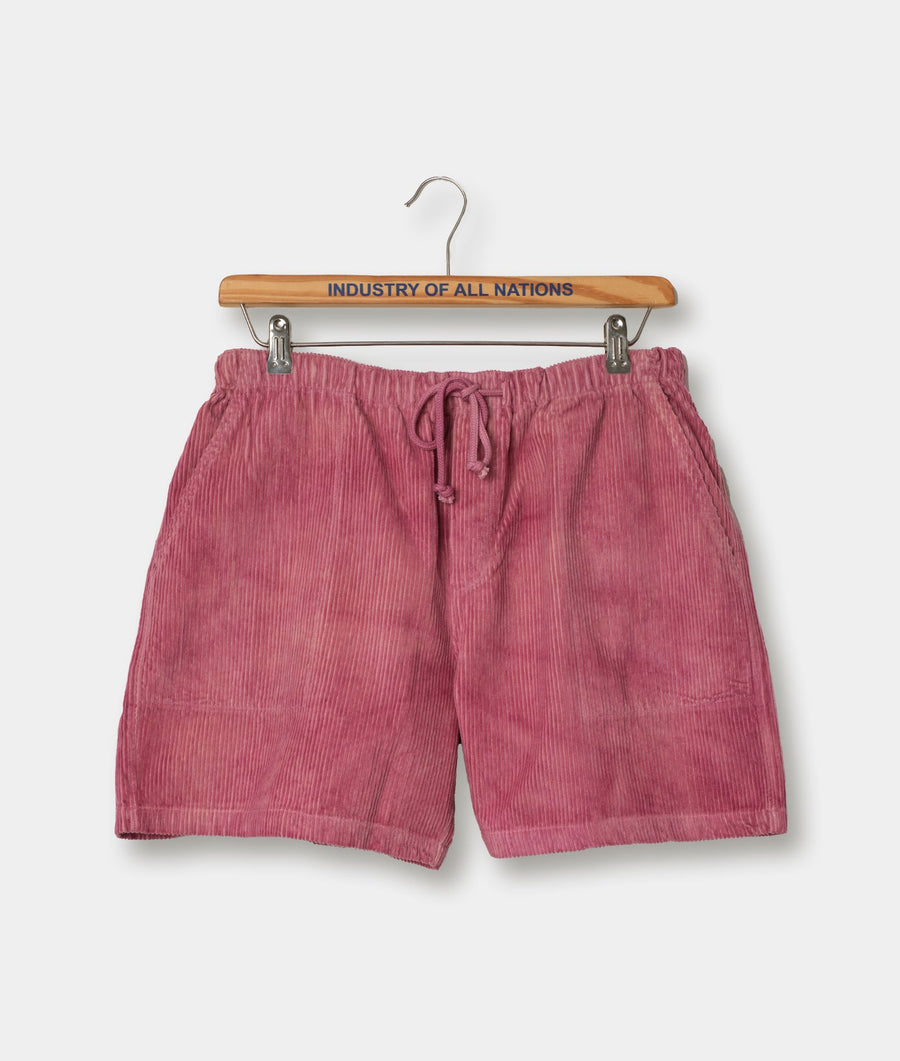 Pink drawstring shorts displayed on a wooden hanger with "Industry of All Nations" text - Industry of All Nations