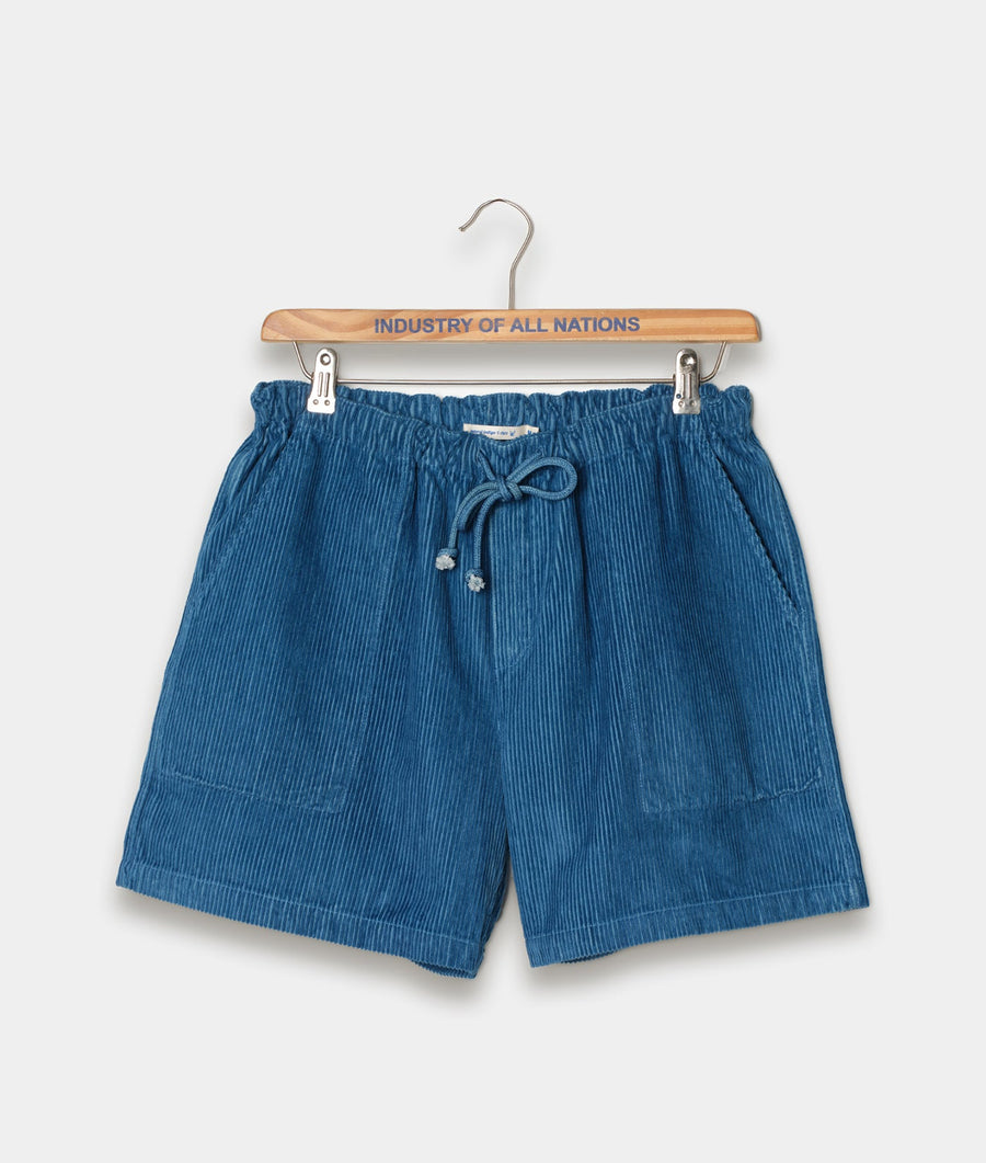 Navy blue pleated shorts with drawstring waist displayed on a wooden hanger with "Industry of All Nations" branding - Industry of All Nations