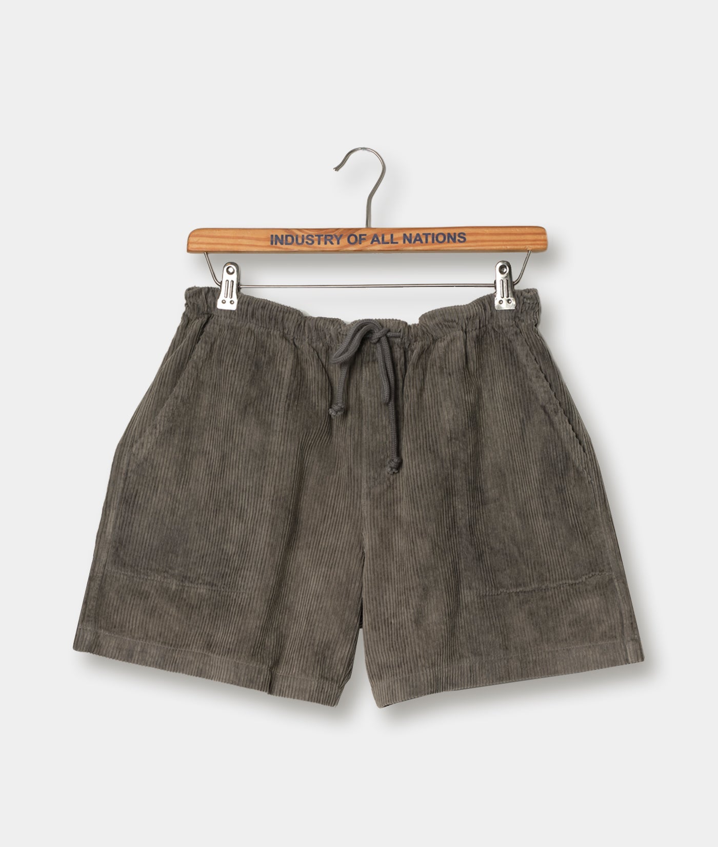 Gray corduroy drawstring shorts displayed on a wooden hanger with a "Industry of All Nations" text label - Industry of All Nations