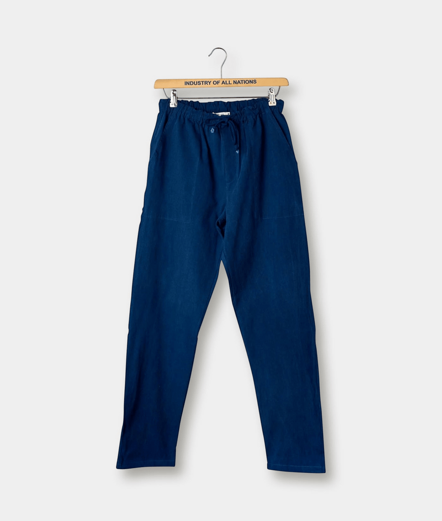 Navy blue cotton drawstring pants hanging on a wooden hanger with "Industry of All Nations" branding - Industry of All Nations