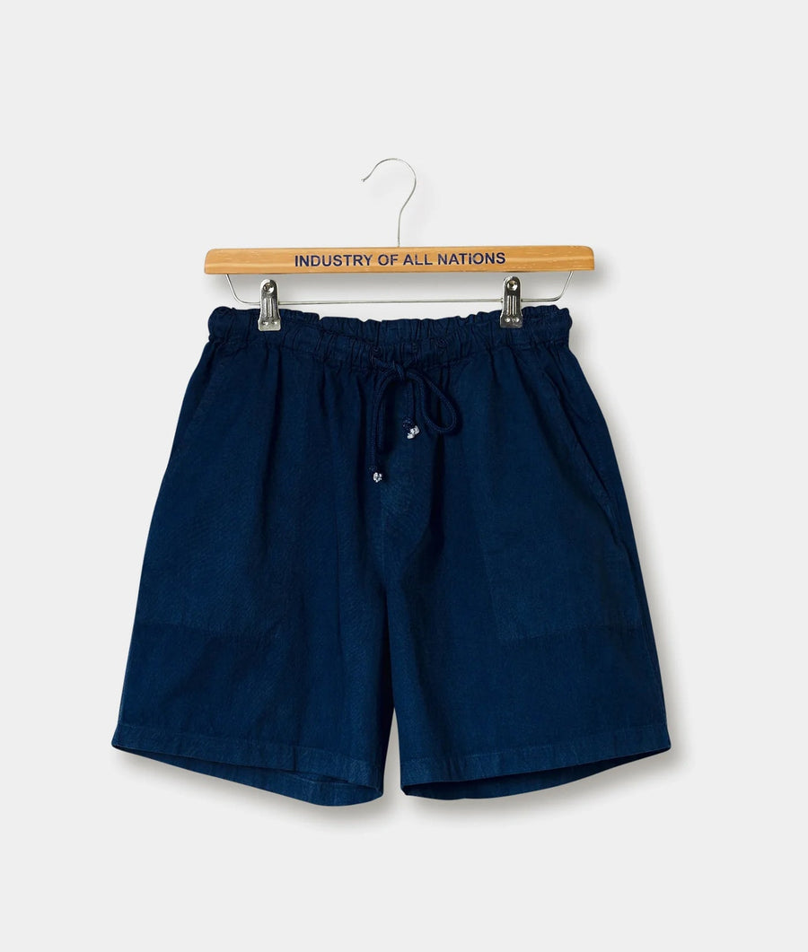 Navy blue drawstring shorts displayed on a wooden hanger with the brand name "Industry of All Nations" printed on it - Industry of All Nations