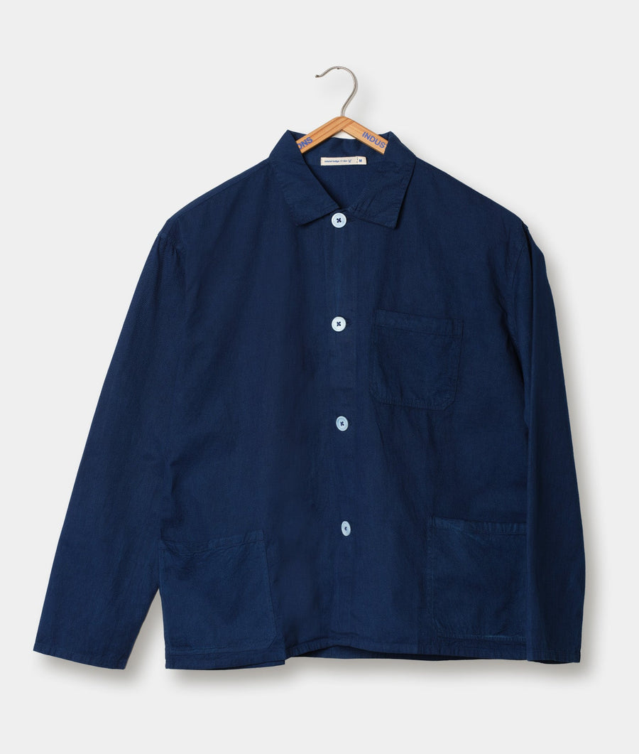Navy blue organic cotton shirt jacket on wooden hanger - Industry of All Nations