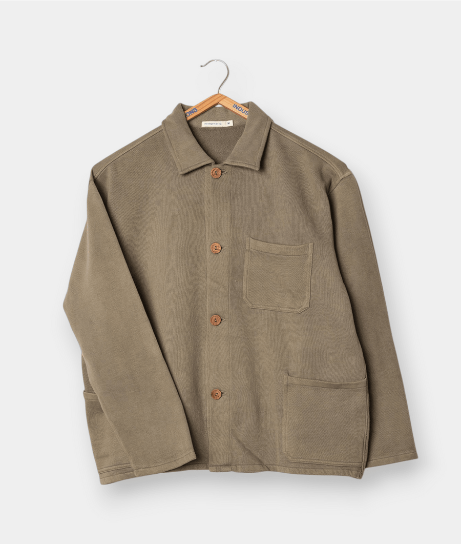 Tan-colored cotton workwear jacket displayed on a clothes hanger - Industry of All Nations