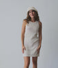 Woman wearing an off white mesh dress and knitted hat against a white background