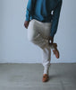Model in a teal indigo-dyed sweatshirt with natural cotton sweatpants and loafers - Industry of All Nations