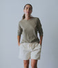 Model in a sage green long-sleeve cotton tee with cream drawstring pants - Industry of All Nations