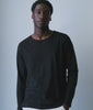 Model wearing a black long-sleeve cotton tee with natural cotton pants - Industry of All Nations