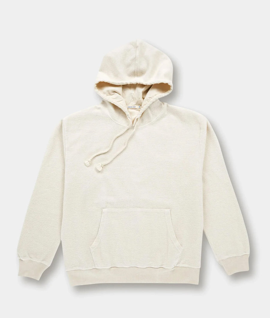 A beige organic cotton pullover hoodie with a front pocket, displayed flat on a white background - Industry of All Nations