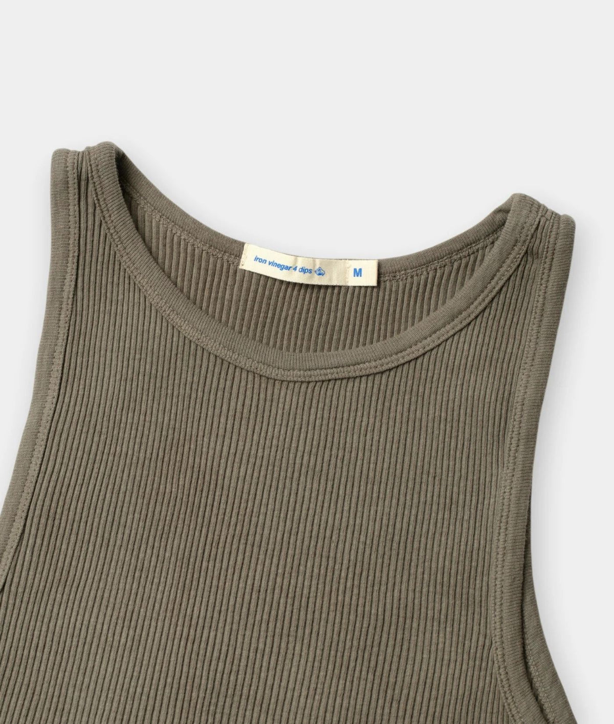 Close-up of a ribbed sleeveless tank top in olive green, showing the crew neckline and a cream-colored inner neck label.