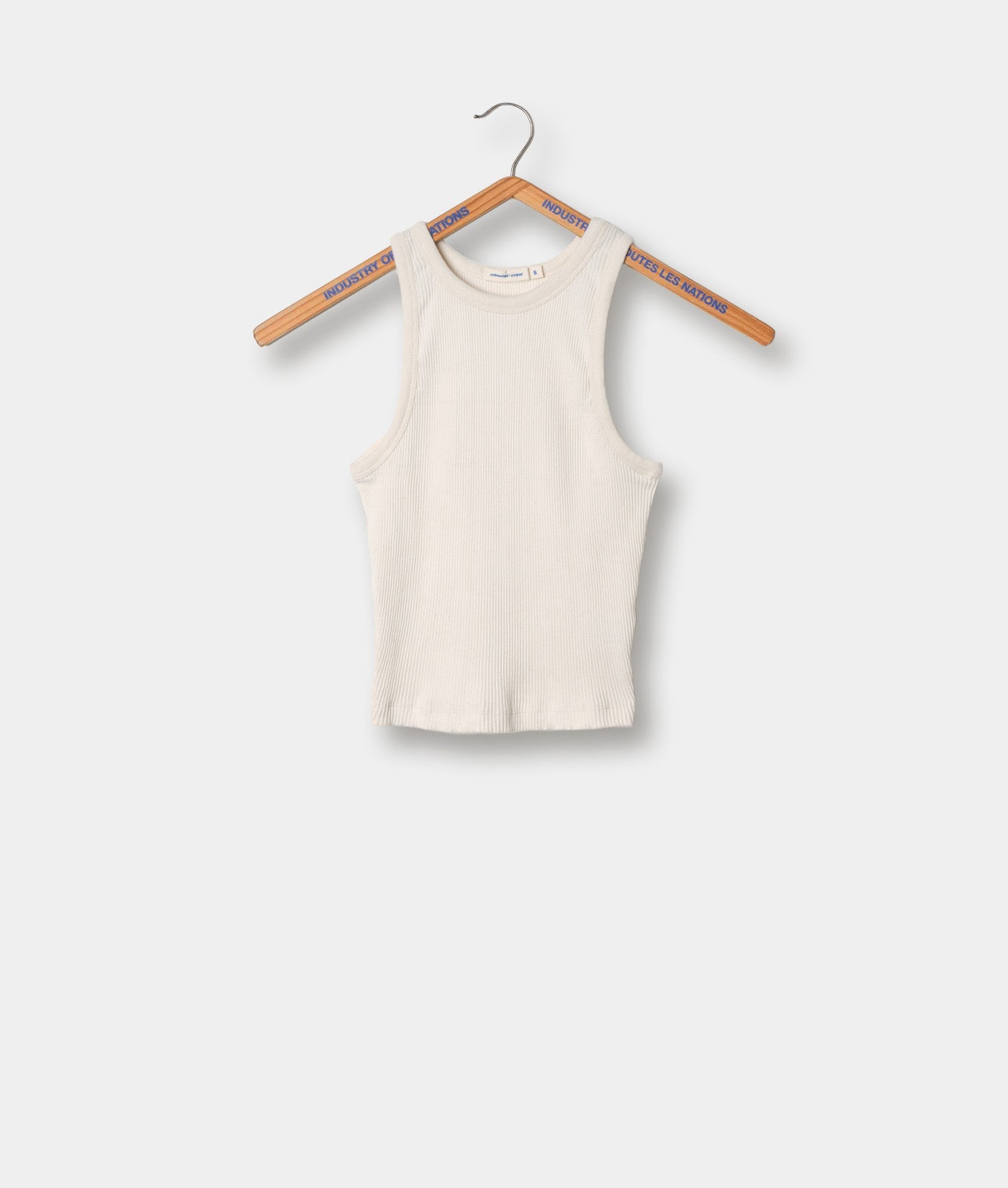 Cream-colored ribbed knit tank top hanging on a wooden clothes hanger - Industry of All Nations