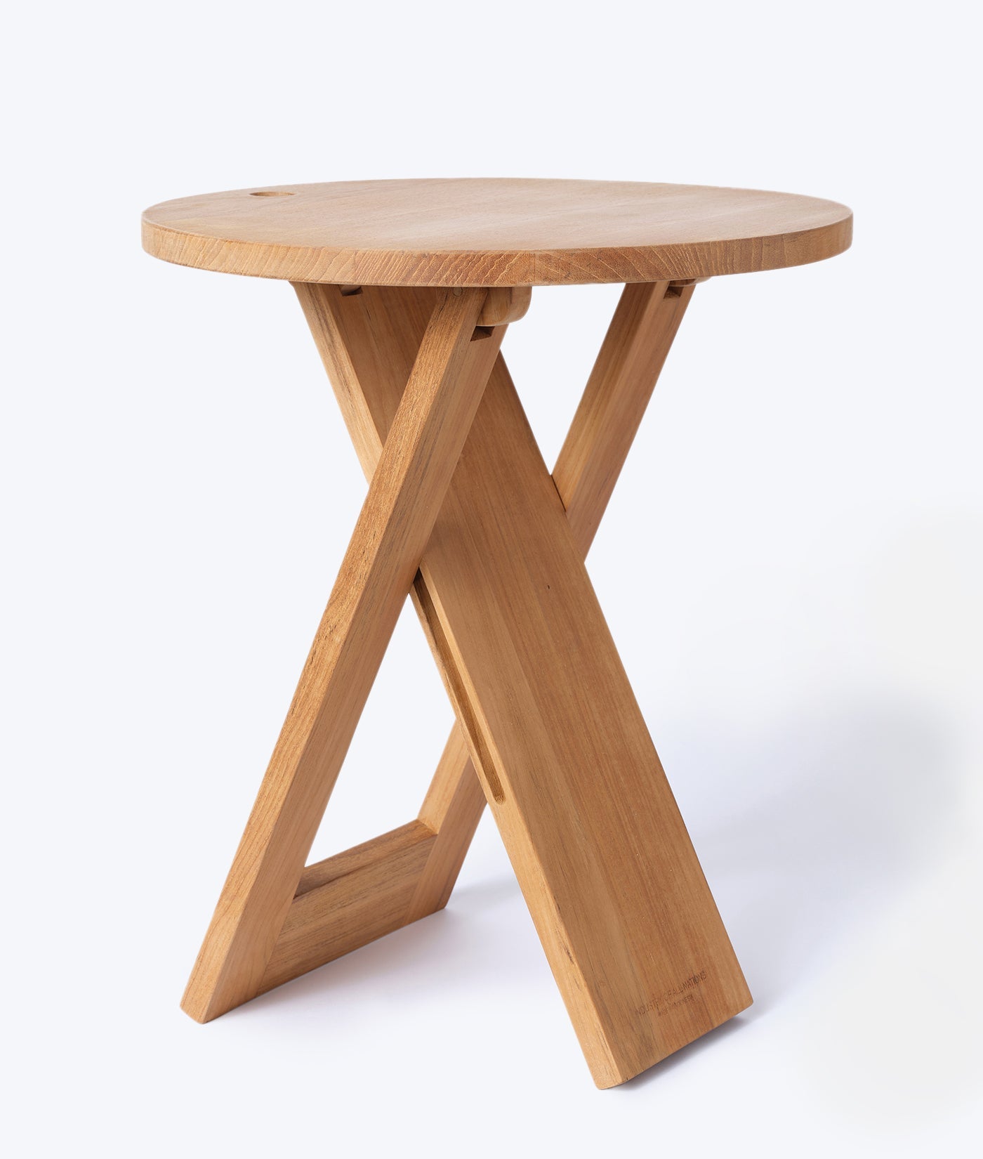 A round wooden side table with an X-shaped base design - Industry of All Nations