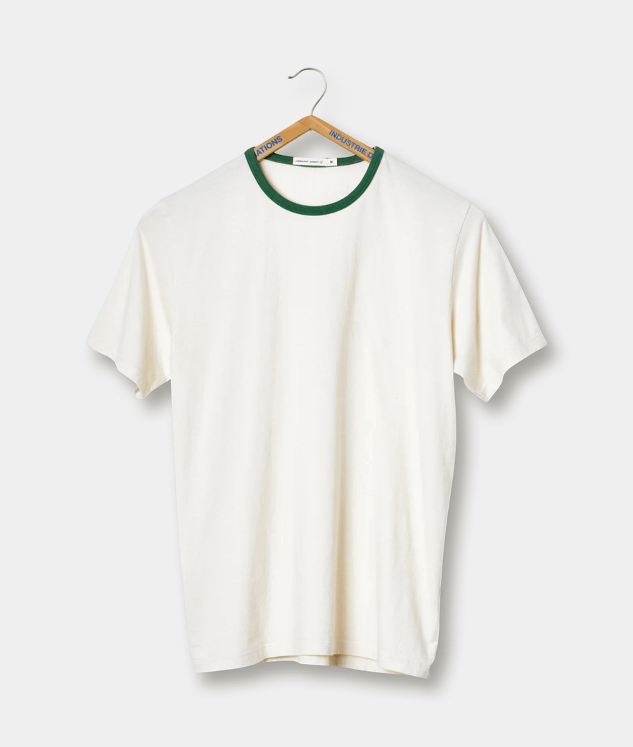 White t-shirt with green collar and "Industrie" logo, hanging on a wooden hanger - Industry of All Nations