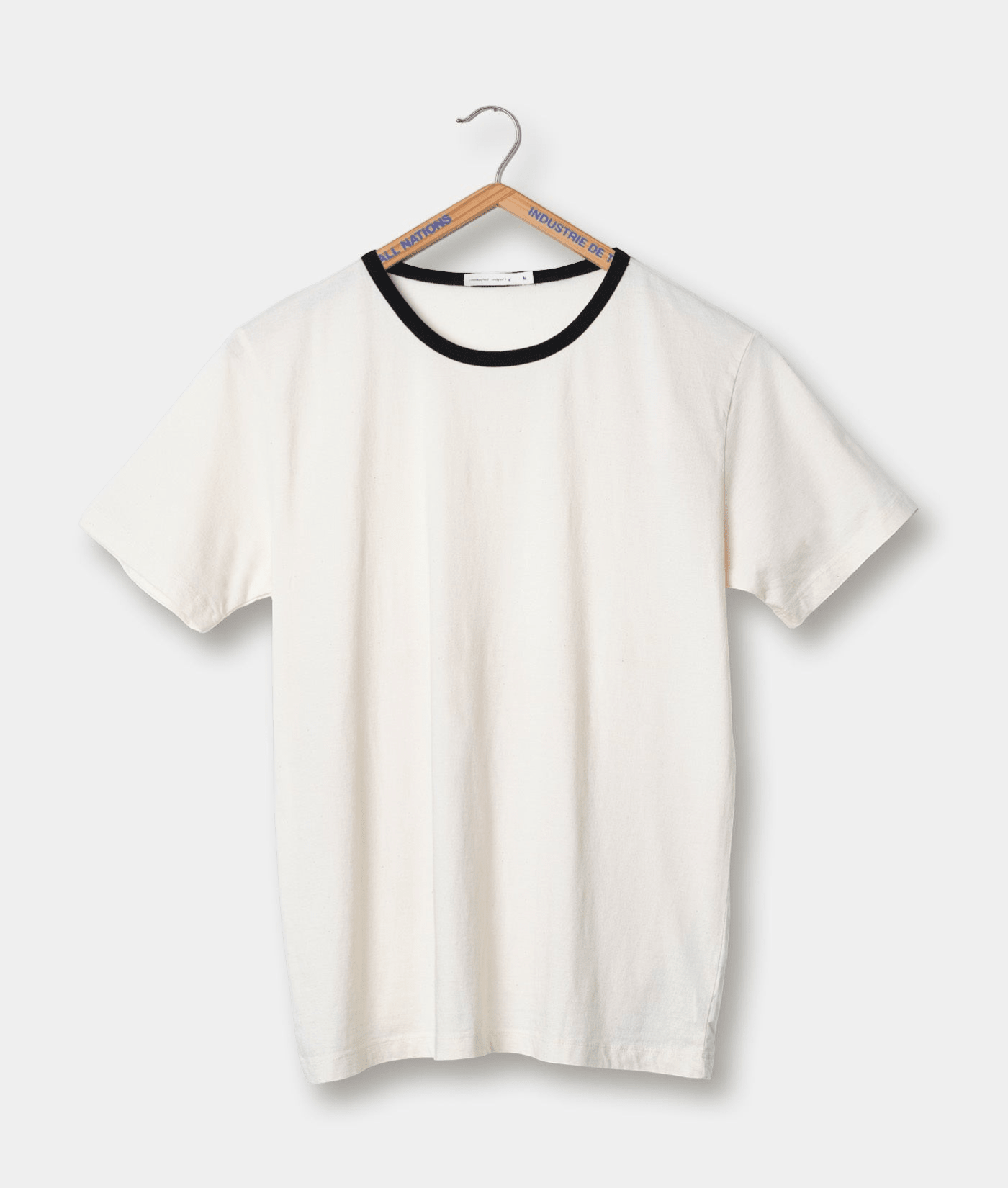White short-sleeved t-shirt on wooden hanger with Industry of All Nations branding - Industry of All Nations