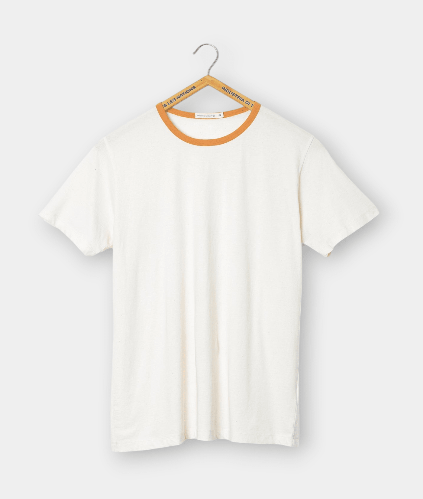 White crew neck t-shirt with orange trim on hanger - Industry of All Nations