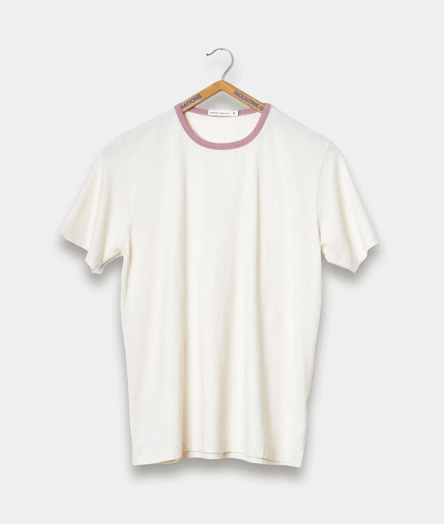 White t-shirt with pink trim, hanging on a hanger - Industry of All Nations