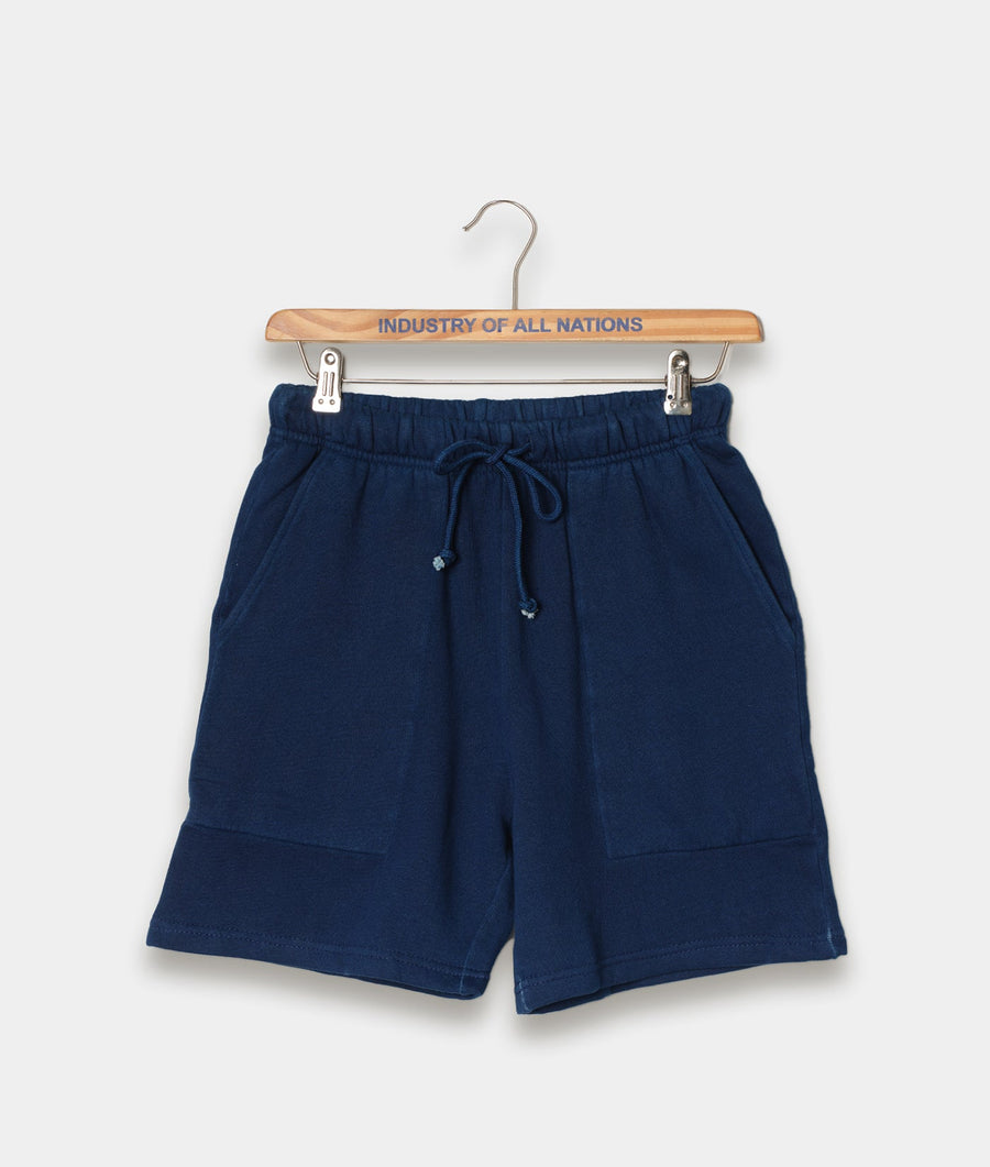 Navy blue cotton drawstring shorts displayed on a wooden hanger with the brand name 'Industry of All Nations' printed on it.