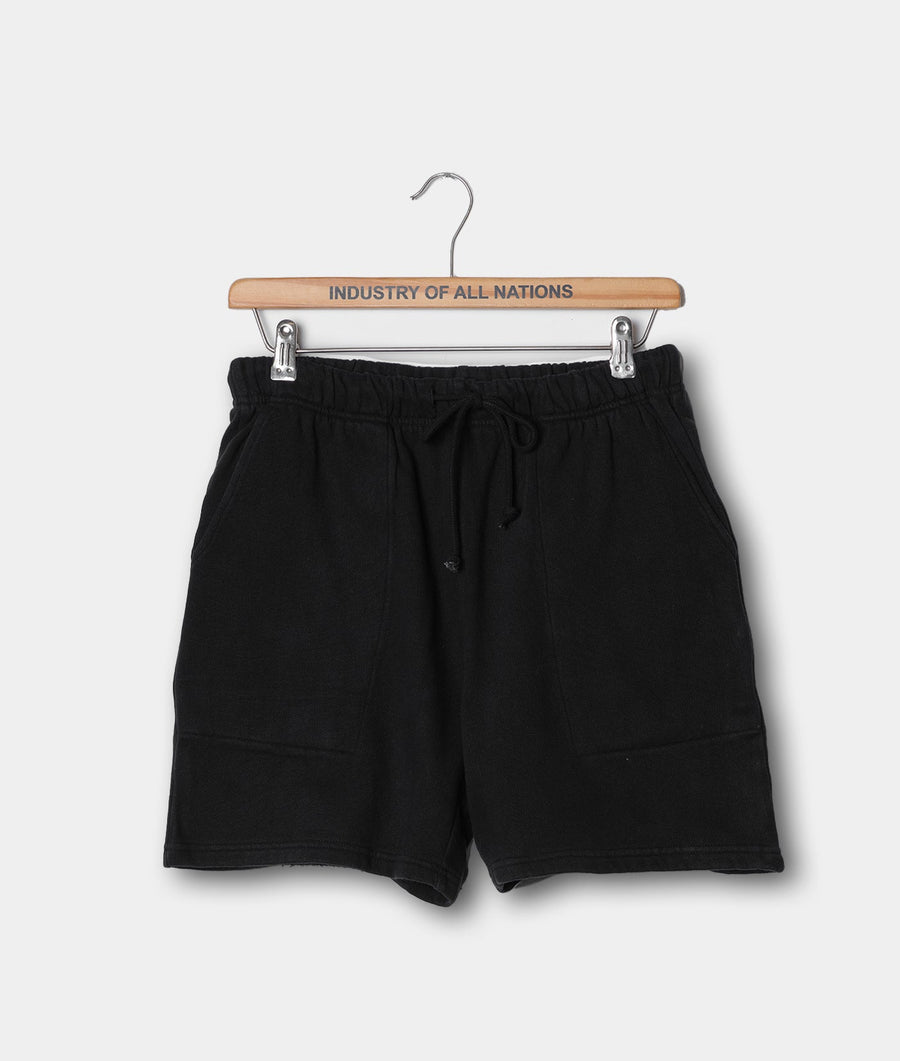 Black cotton shorts with drawstring waist, displayed on a wooden hanger with "Industry of All Nations" text - Industry of All Nations