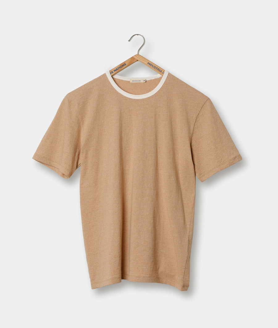 Beige crew-neck t-shirt hanging on a wooden hanger with 'Industrial' branding - Industry of All Nations