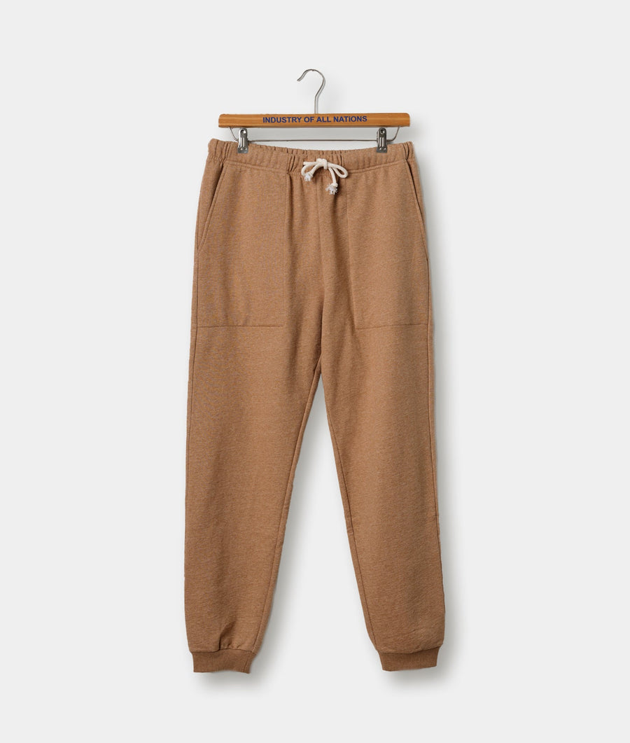 Tan colored sweatpants or joggers in a flat lay display with an "Industry of All Nations" branded hanger - Industry of All Nations