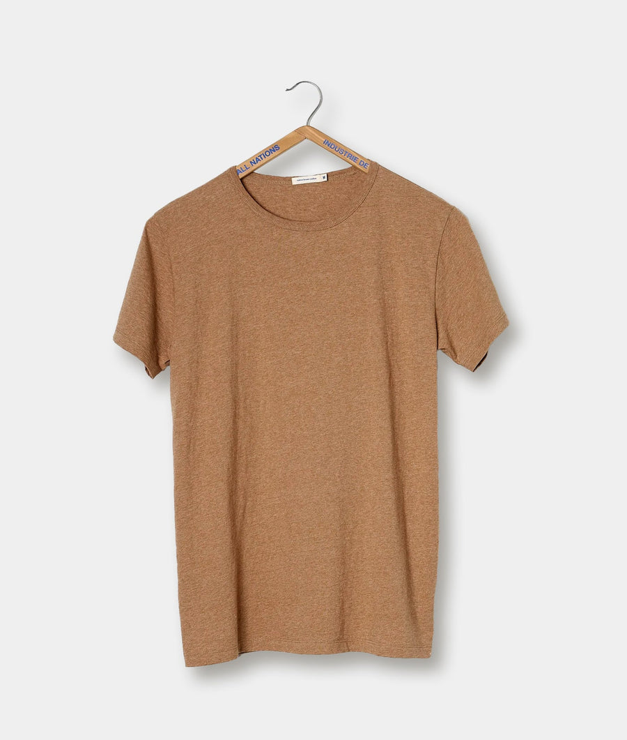 Tan colored T-shirt hanging on a black metal hanger with 'Industry of All Nations' branding - Industry of All Nations