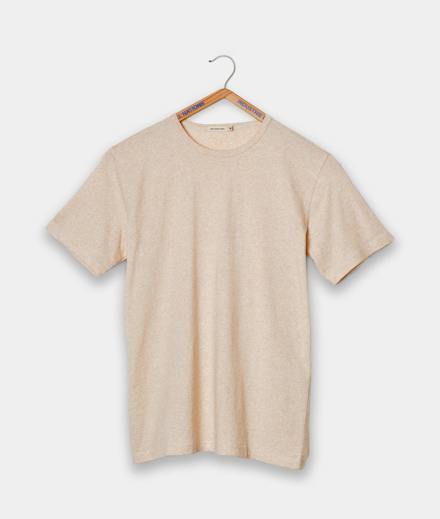 Tan crew neck t-shirt hanging on a wooden hanger with 'INDUSTRY' printed on it - Industry of All Nations