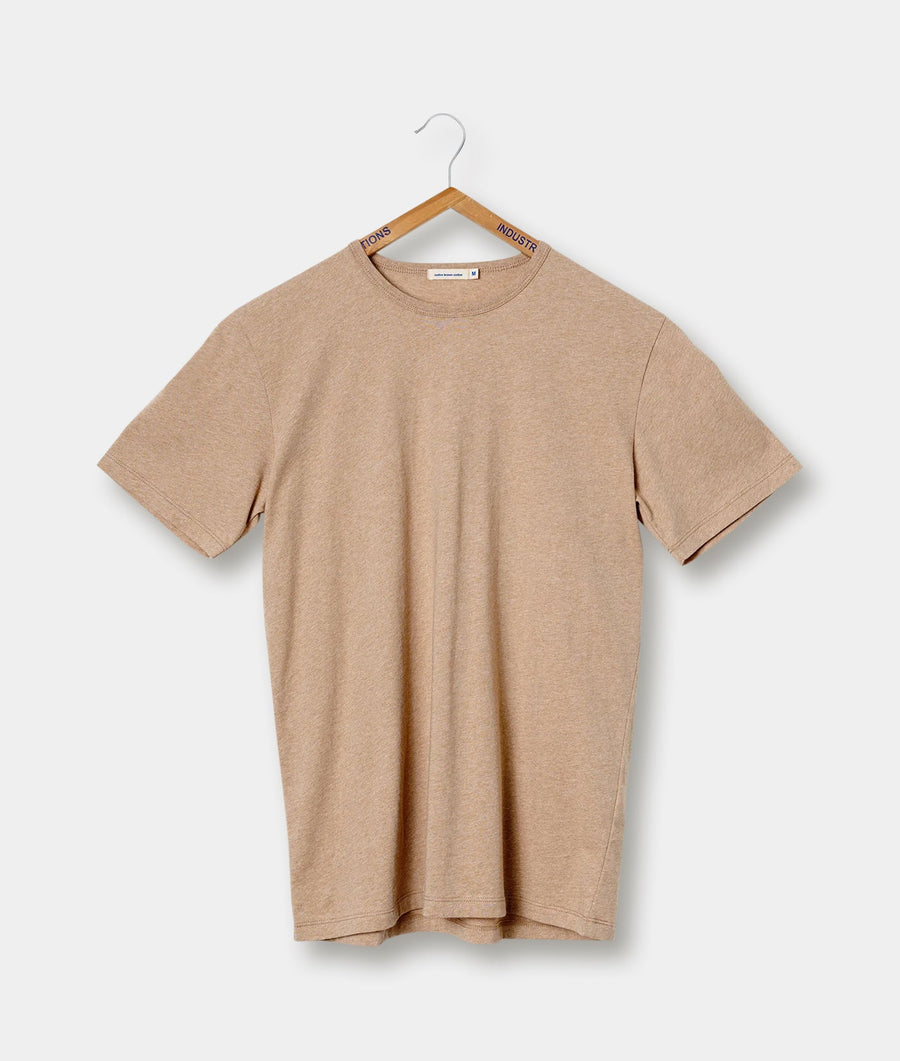 Beige crew neck t-shirt hanging on a hanger with "Industry of All Nations" branding - Industry of All Nations