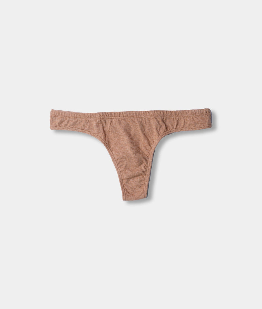Tan colored cotton underwear in a thong style, laid flat on a plain white background - Industry of All Nations
