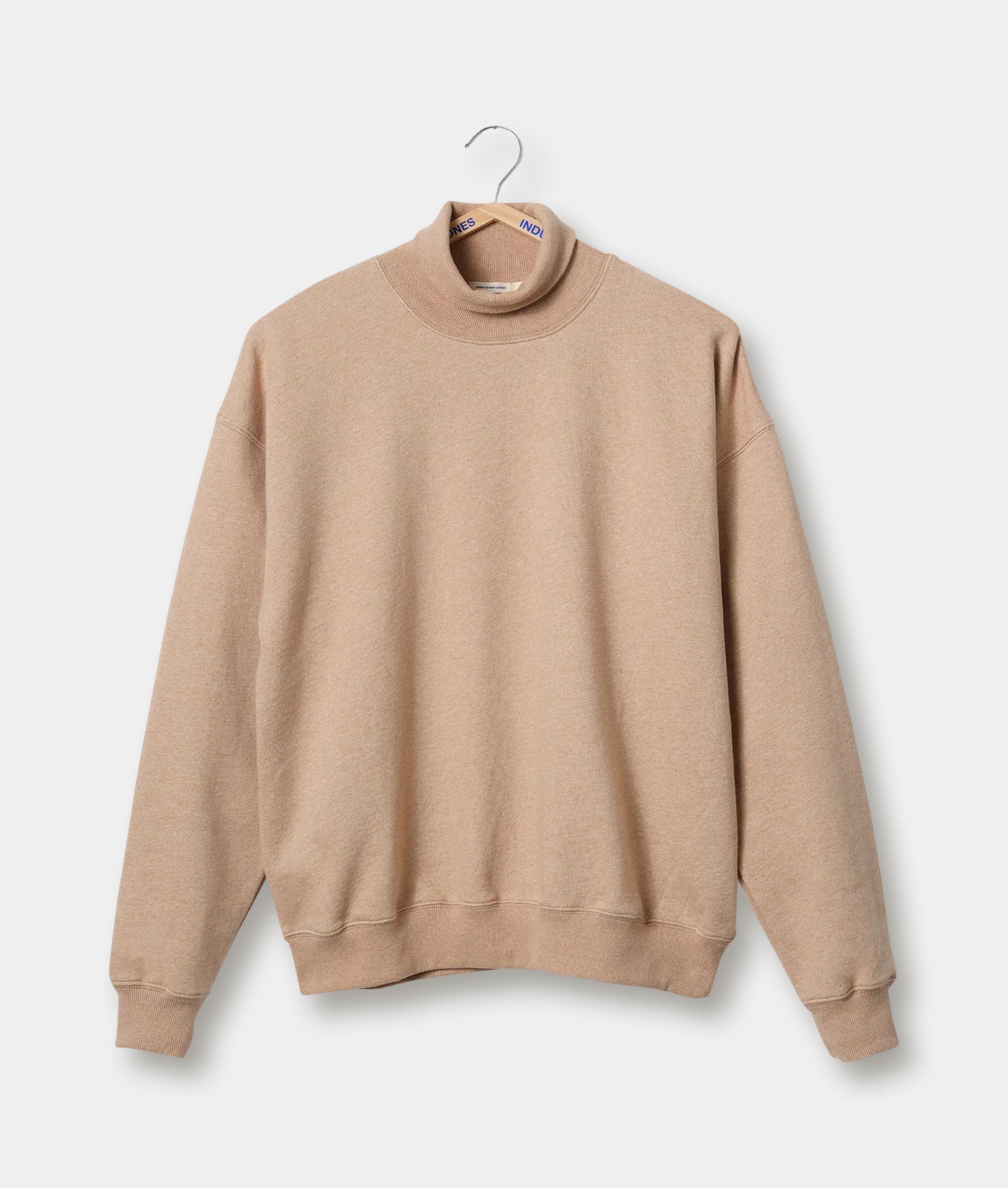 Beige turtleneck sweater displayed on a hanger - Industry of All Nations
