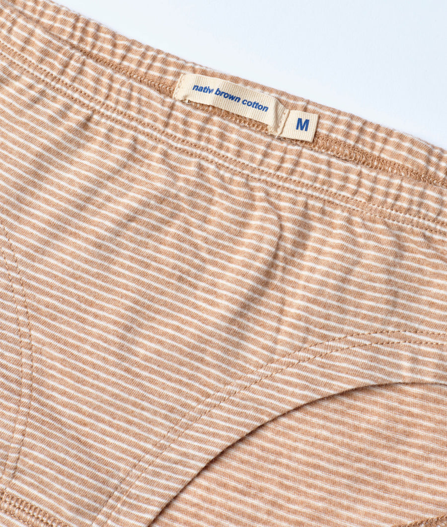 Close-up detail shot of a beige and white striped cotton men's boxer shorts with a "nativ brown cotton" label - Industry of All Nations