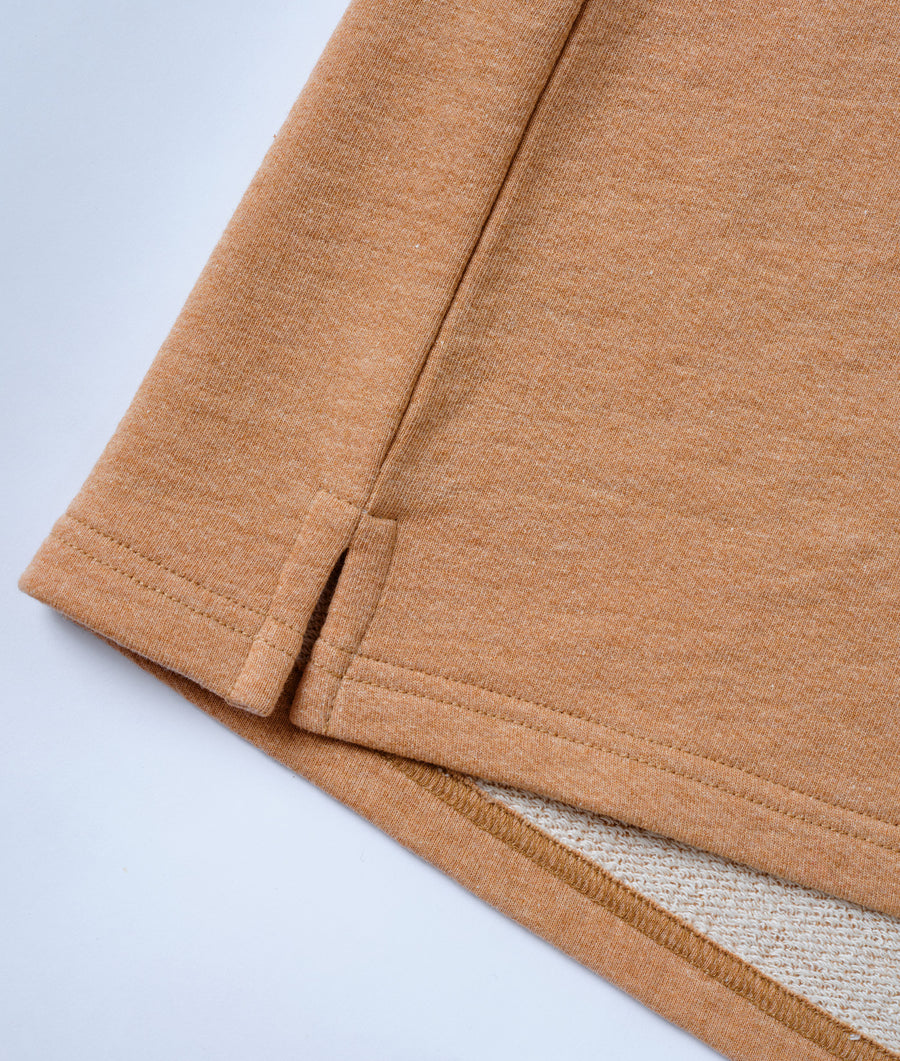 Close-up shot of a tan colored organic cotton t-shirt displayed flat - Industry of All Nations