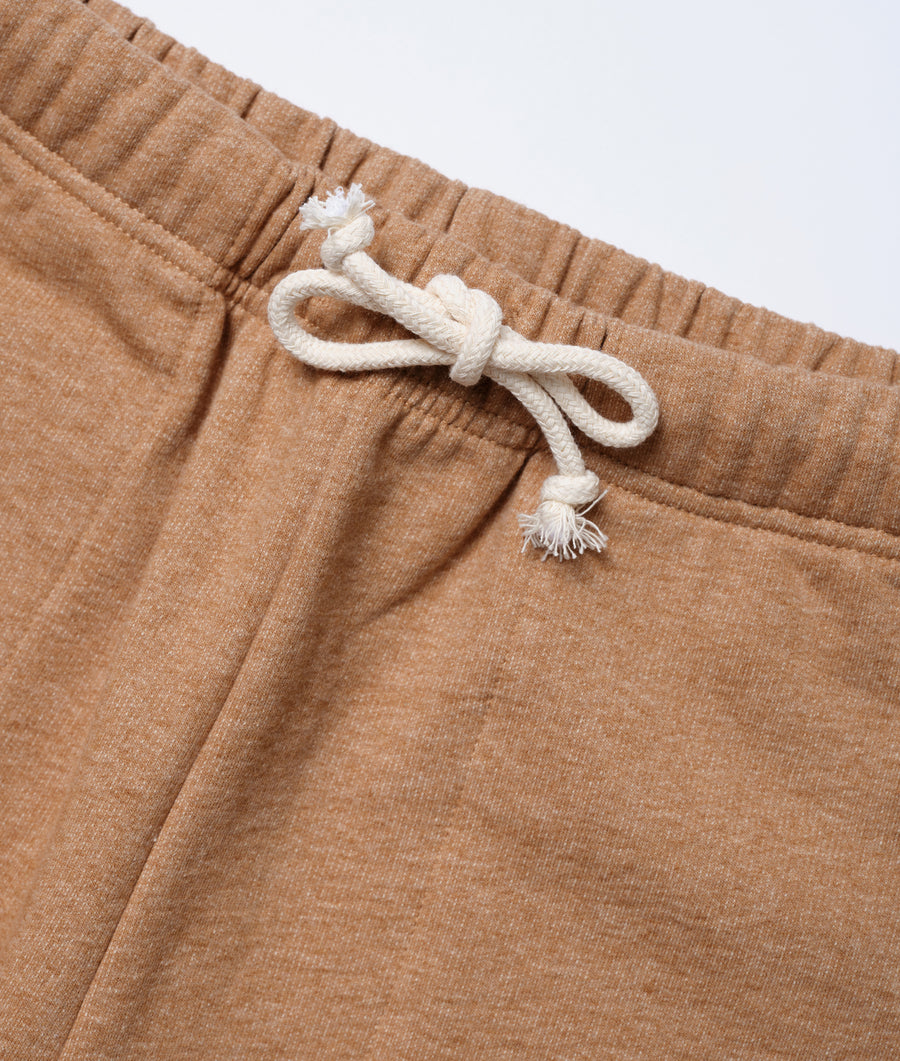 Close-up detail of a tan colored pair of drawstring organic cotton shorts - Industry of All Nations