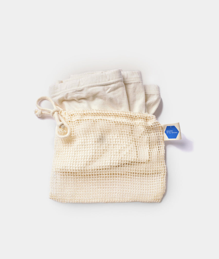 Mesh drawstring bags made of organic cotton, displayed in a flat lay arrangement - Industry of All Nations