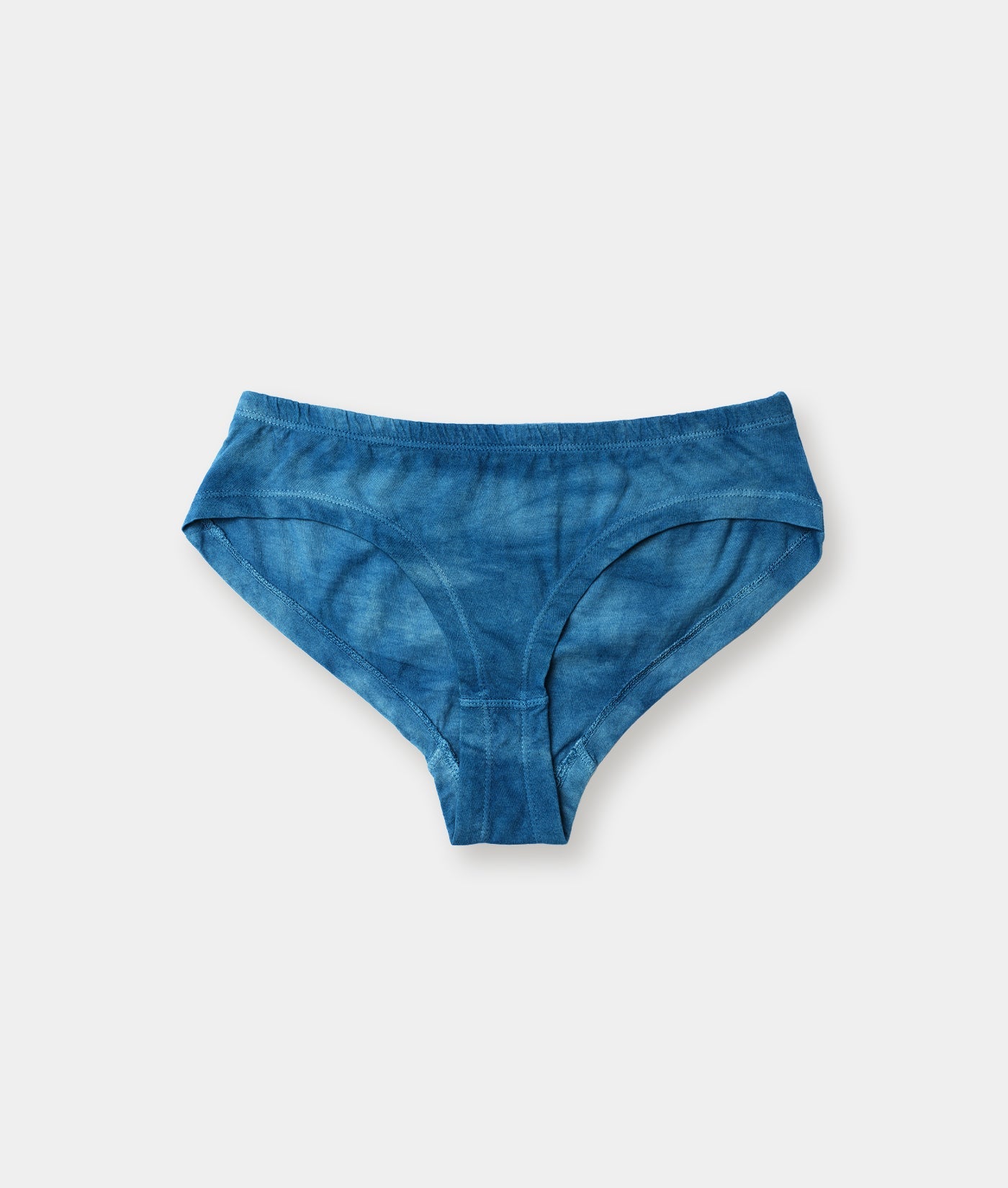 Blue tie-dye organic cotton briefs displayed on a flat surface - Industry of All Nations